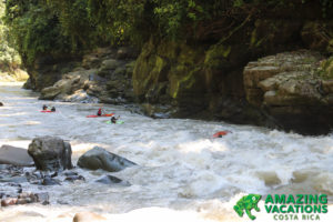 kayakers running rapids