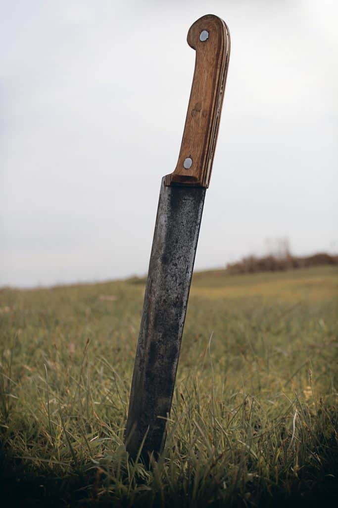 A machete stuck in the ground