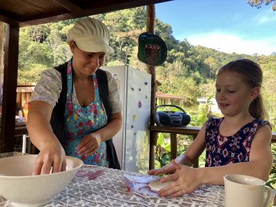 Help make food to eat before you take a seat.